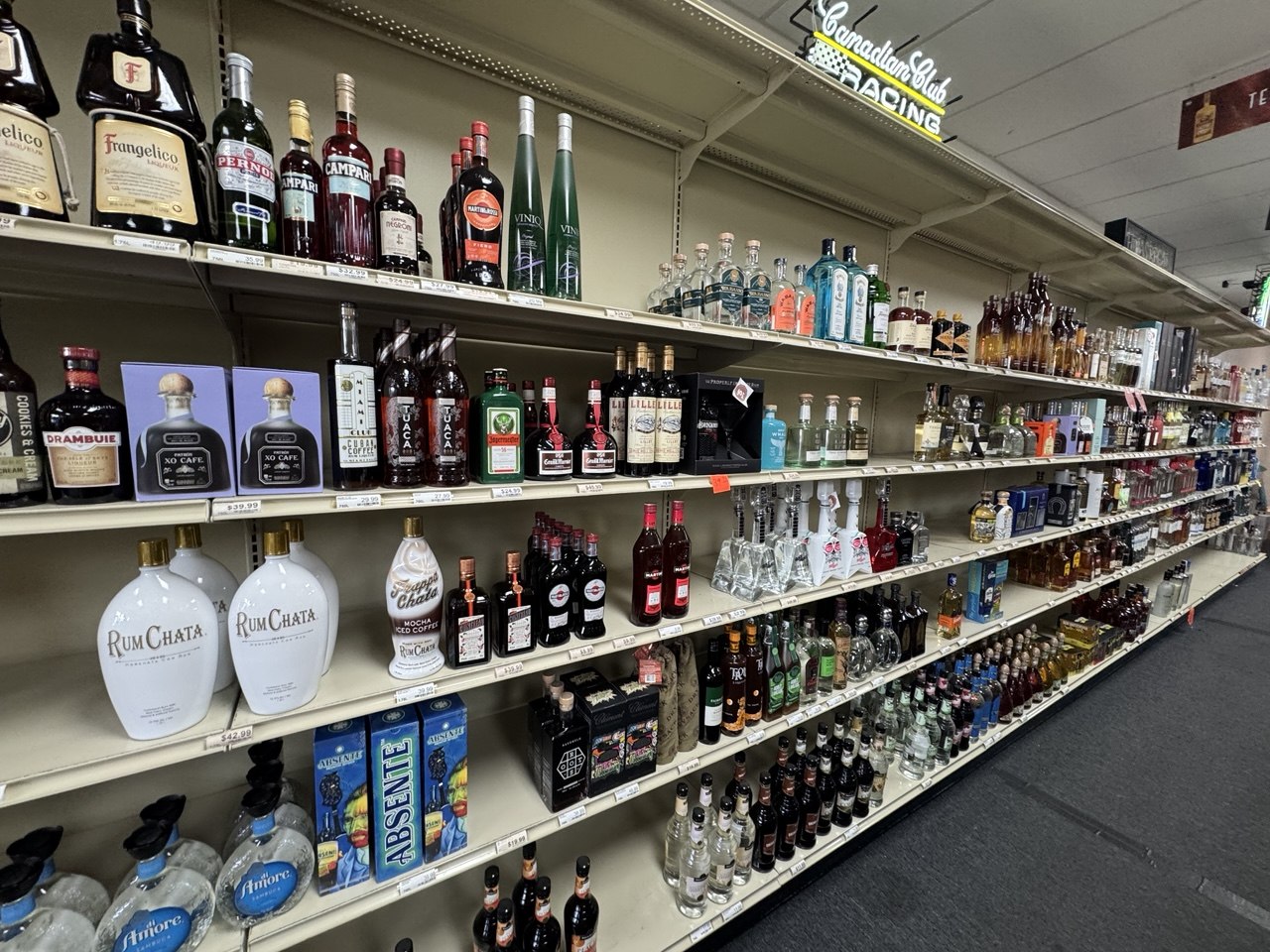 Liquor store shelf detail showing bottle variety for commercial liquidation
